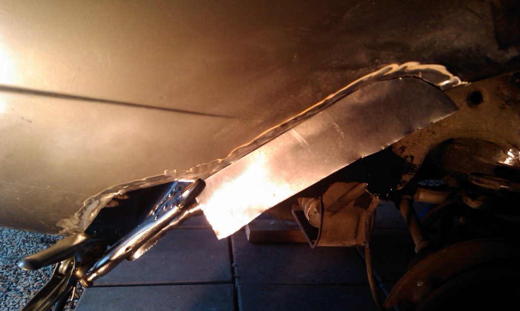 Welding metal into the wheel arch
