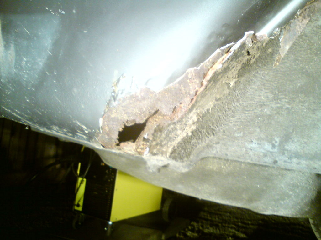 rusted right rear wheel arch