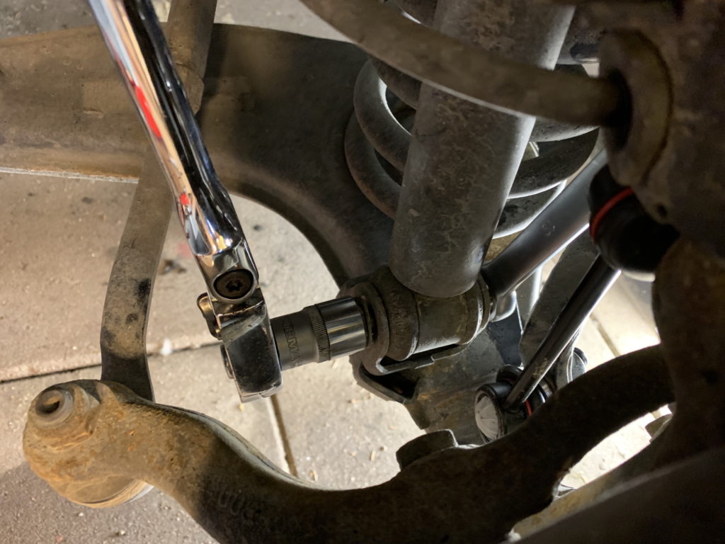 Removing lower bolt on damper