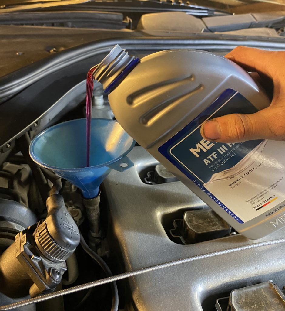 Pouring in new transmission fluid